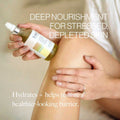 Applying Esker Restorative Body Oil to the thigh for deep nourishment
