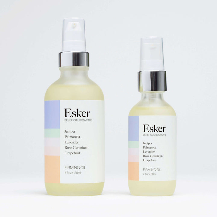 Esker Firming Oil Deluxe Mini next to the full-size Firming Body Oil